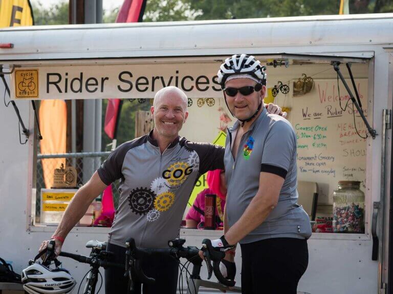 Two riders taking a break in a cycling event.